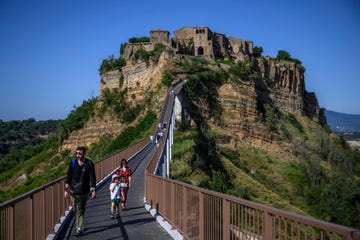 bagnoregio, italy july 07 tourists visit the village of civita di bagnoregio, on july 7, 2024 in bagnoregio, italy civita di bagnoregio is a small village of the municipality of bagnoregio near viterbo, lazio region, where 11 people live the only access is a footbridge from the nearby town, with a toll introduced in 2013 thanks to its evocative geographical position and its medieval buildings, the town attracts many tourists, and several times it has been used as a movie set civita di bagnoregio, the so called dying city, is candidate for recognition as unesco world heritage site photo by antonio masiellogetty images