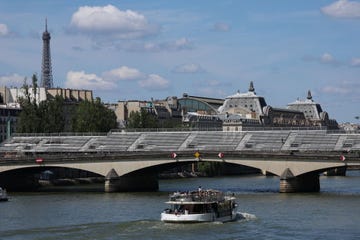 a tourist boat is navigated towards grandstands set up for the paris 2024 olympics opening ceremony along the seine river in paris on july 17, 2024, ahead of the paris 2024 olympic and paralympic games photo by emmanuel dunand afp photo by emmanuel dunandafp via getty images