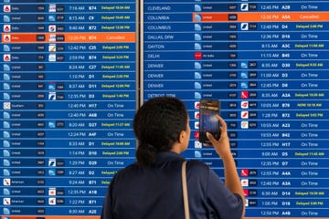 washington, dc july 19  a woman uses the camera on her phone to record a flight information board showing multiple delays and some cancellations in flight departures from dulles international airport on july 19, 2024 in dulles, virginia businesses including airlines worldwide were affected by a global technology outage that was attributed to a software update issued by crowdstrike, a cybersecurity firm whose software is used by many industries around the world photo by roberto schmidtgetty images