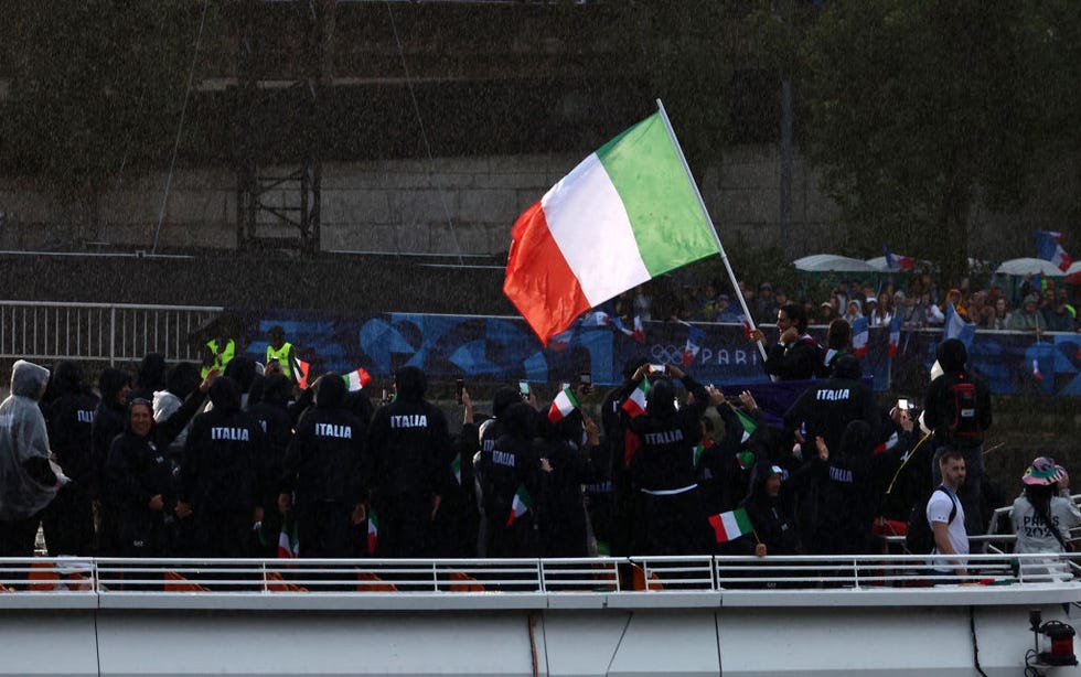 paris, france july 26 arianna errigo and gianmarco tamberi, flagbearers of team italy, wave their flag on a boat sailing along the river seine during the opening ceremony of the olympic games paris 2024 on july 26, 2024 in paris, france photo by vcgvcg via getty images