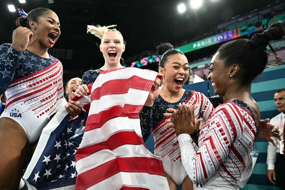 us' simone biles r and teammates celebrate after team usa won the artistic gymnastics women's team final during the paris 2024 olympic games at the bercy arena in paris, on july 30, 2024 photo by lionel bonaventure afp