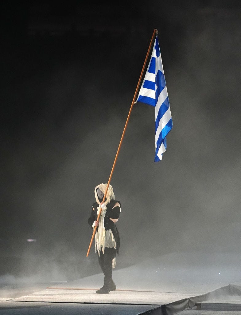 a performer with the national flag of greece during the closing ceremony of the 2024 paris olympic games, at the stade de france, paris picture date sunday august 11, 2024 photo by peter byrnepa images via getty images