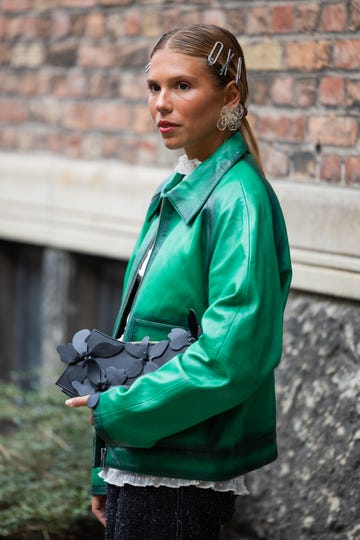 copenhagen, denmark august 08 rita montezuma wears green leather jacket, denim jeans, hair clips, green bag outside rotate during day four of the copenhagen fashion week cphfw ss25 on august 08, 2024 in copenhagen, denmark photo by christian vieriggetty images