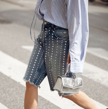 Street Style - Day 4 - Copenhagen Fashion Week SS25 copenhagen, denmark august 08: a guest wears denim shorts with metal details, flip flops, blue and white striped shirt and silver bag outside the gestuz show during day four of the copenhagen fashion week (cphfw) ss25 on august 08, 2024 in copenhagen, denmark. (photo by raimonda kulikauskiene/getty images)