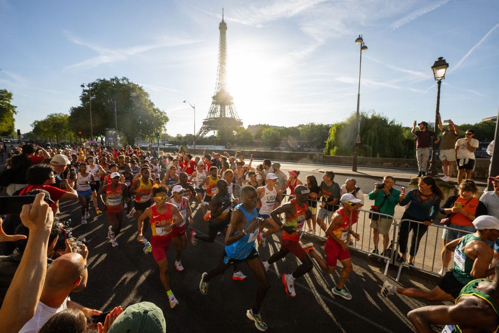 paris, france august 10 eliud kipchoge of team kenya, gabriel gerald geay of team tanzania, jie he and shahoui yang of team peoples republic of china run past eiffel tower during the mens marathon during day fifteen of the olympic games paris 2024 at esplanade des invalides on august 10, 2024 in paris, france photo by david ramosgetty images