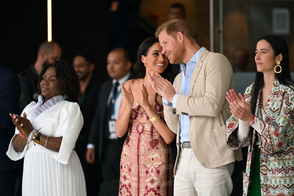 britains prince harry 2nd r, duke of sussex, speaks with his wife meghan markle, flanked by colombias vice president francia marquez l and the director of the national centre for the arts xiomara suescun attend a performance at the centre in bogota on august 15, 2024 prince harry and his wife, american actress meghan markle, arrived in colombia at the invitation of marquez, with whom they will attend various meetings with women and young people to reject discrimination and cyberbullying photo by raul arboleda afp photo by raul arboledaafp via getty images