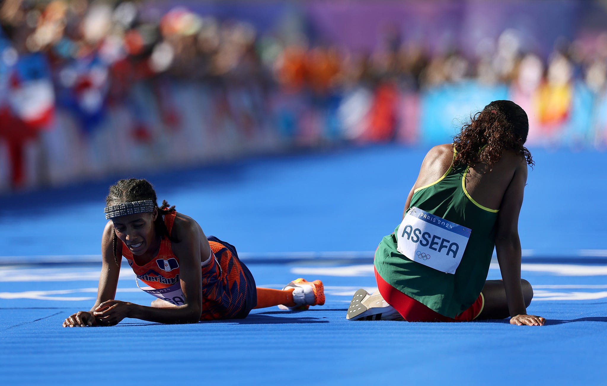 paris, france august 11: sifan hassan of team netherlands and tigst assefa of team ethiopia react after crossing the finish line during the womens marathon on day sixteen of the olympic games paris 2024 at esplanade des invalides on august 11, 2024 in paris, france. (photo by cameron spencer/getty images)