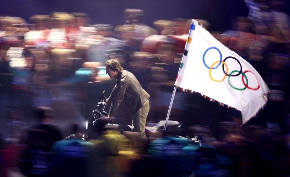 paris, france august 11 american actor and film producer tom cruise rides on a motorbike with the ioc flag during the closing ceremony of the olympic games paris 2024 at stade de france on august 11, 2024 in paris, france photo by steph chambersgetty images