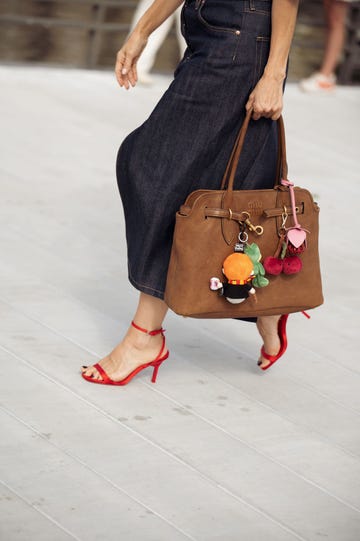 copenhagen, denmark august 08 renia jaz wears white t shirt, navy blue skirt, brown bag with accessories and sunglasses outside the marimekko show during day four of the copenhagen fashion week cphfw ss25 on august 08, 2024 in copenhagen, denmark photo by raimonda kulikauskienegetty images