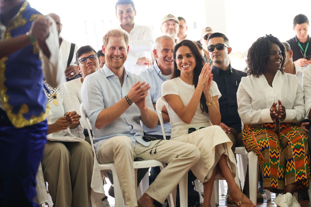 Meghan does laid-back luxe in a white t-shirt and embroidered skirt