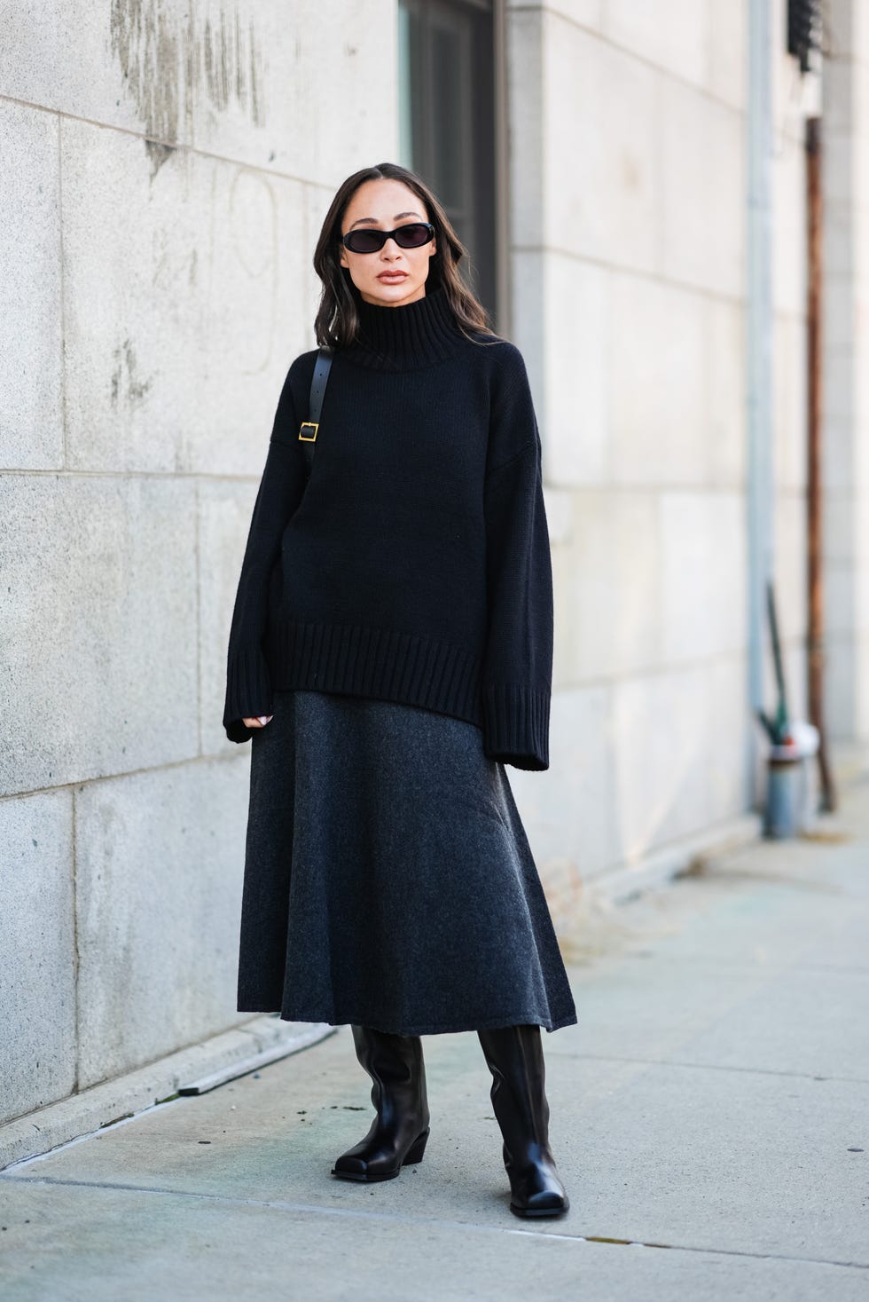 new york, new york september 10 a guest wears black sunglasses, black leather bag, black oversized turtleneck sweater, black midi skirt, shiny black heeled boots leather shoes, outside cos, during the new york fashion week springsummer 2025 on september 10, 2024 in new york, new york photo by edward berthelotgetty images