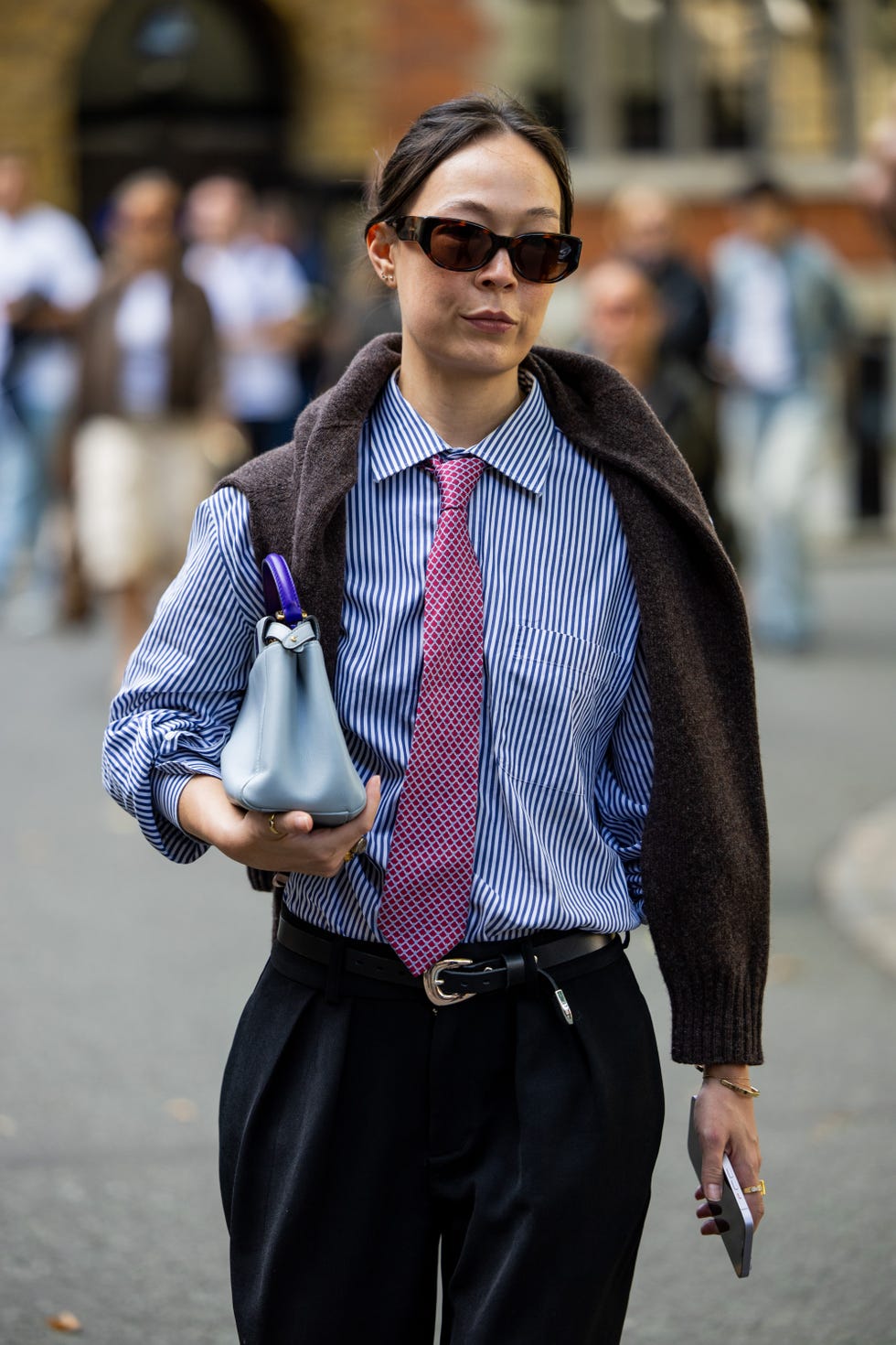 london, england september 14 a guest wears blue white striped button shirt, pink tie, bag outside ahluwalia during london fashion week september 2024 on september 14, 2024 in london, england photo by christian vieriggetty images