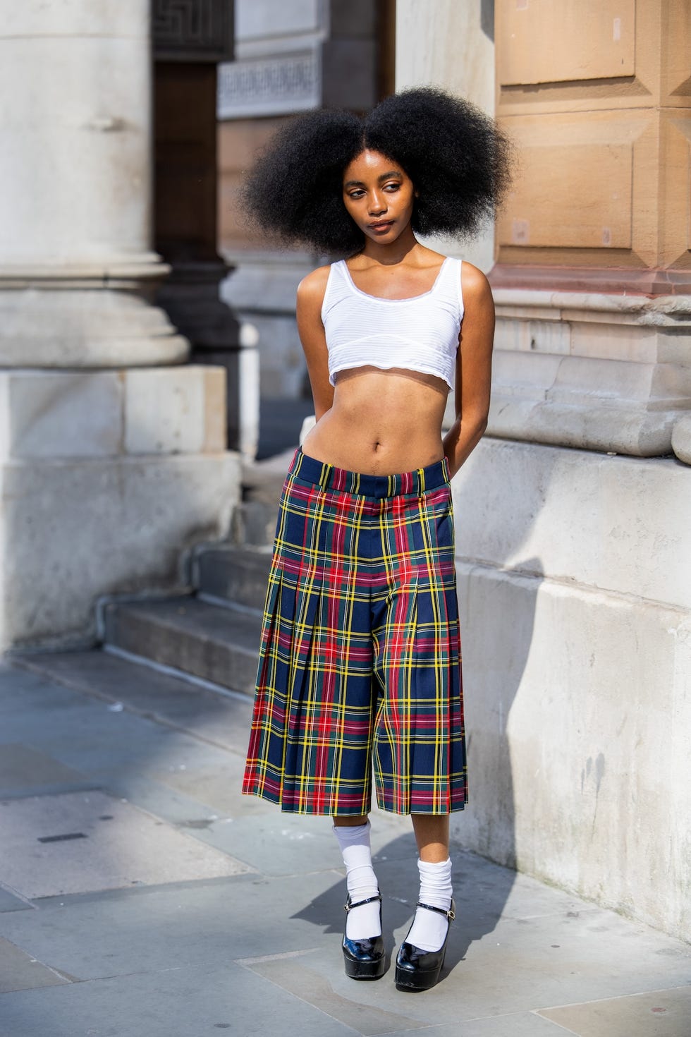 london, england september 14 joyce cisse wears white cropped shirt, checkered navy red blue shorts, white socks, platform heels outside kent  curwen during london fashion week september 2024 on september 14, 2024 in london, england photo by christian vieriggetty images