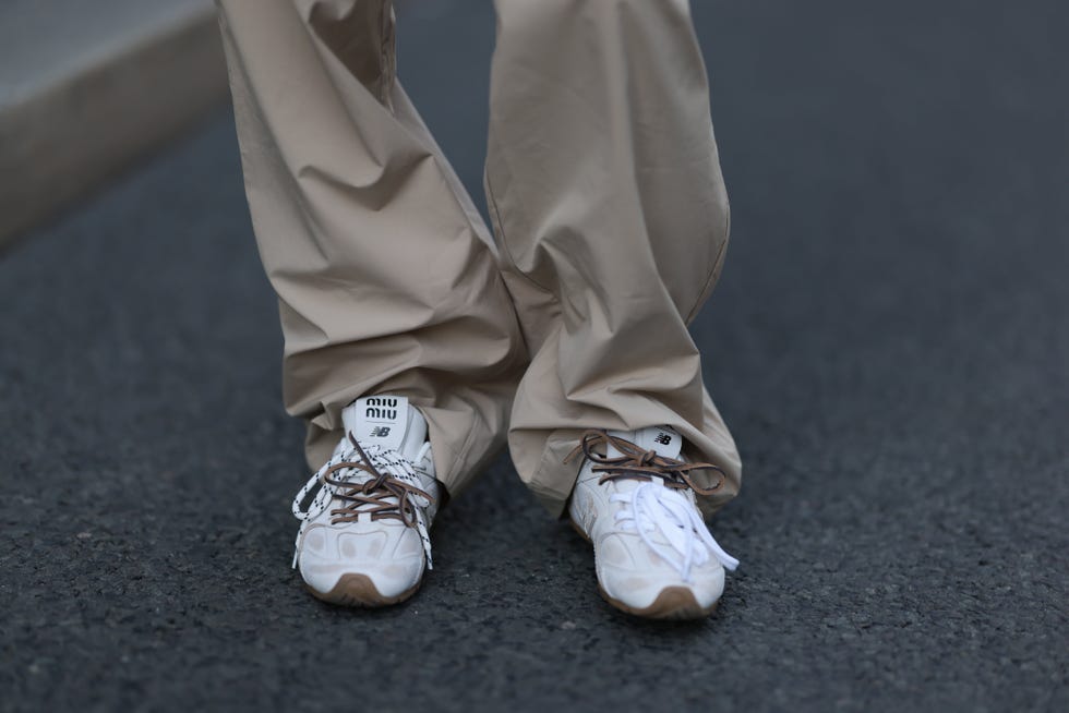 Berlin, Germany, September 18, 2024 Sophia Geis is seen wearing beige long pants with a layered plan and white beige leather sneakers by New Balance x Miu Miu, Berlin, Germany, September 18, 2024 Photography by Jeremy Moraghetti Images