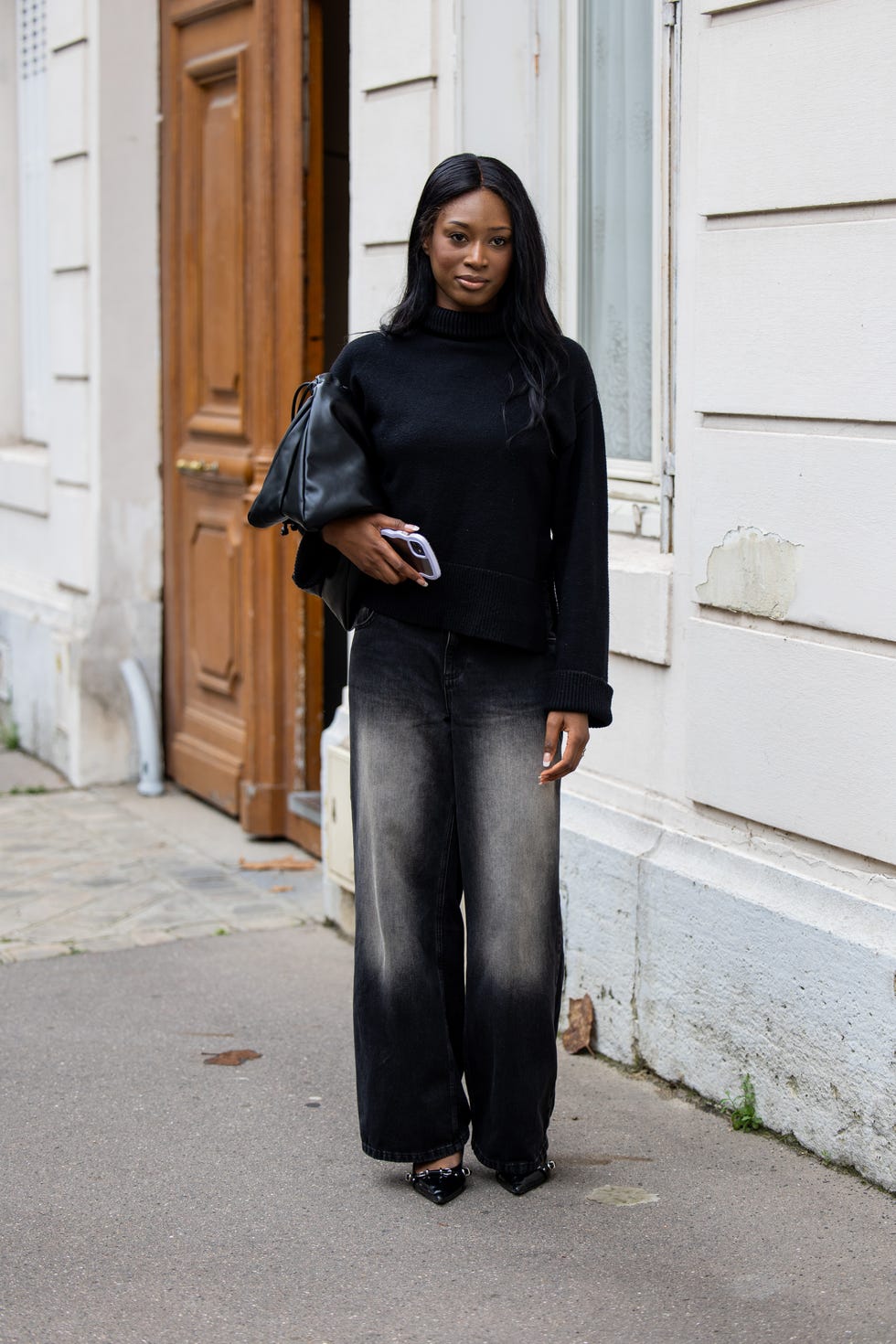 paris, france september 24 a guest wears black turtleneck, black white washed pants, bag outside dior during womenswear springsummer 2025 as part of paris fashion week on september 24, 2024 in paris, france photo by christian vieriggetty images