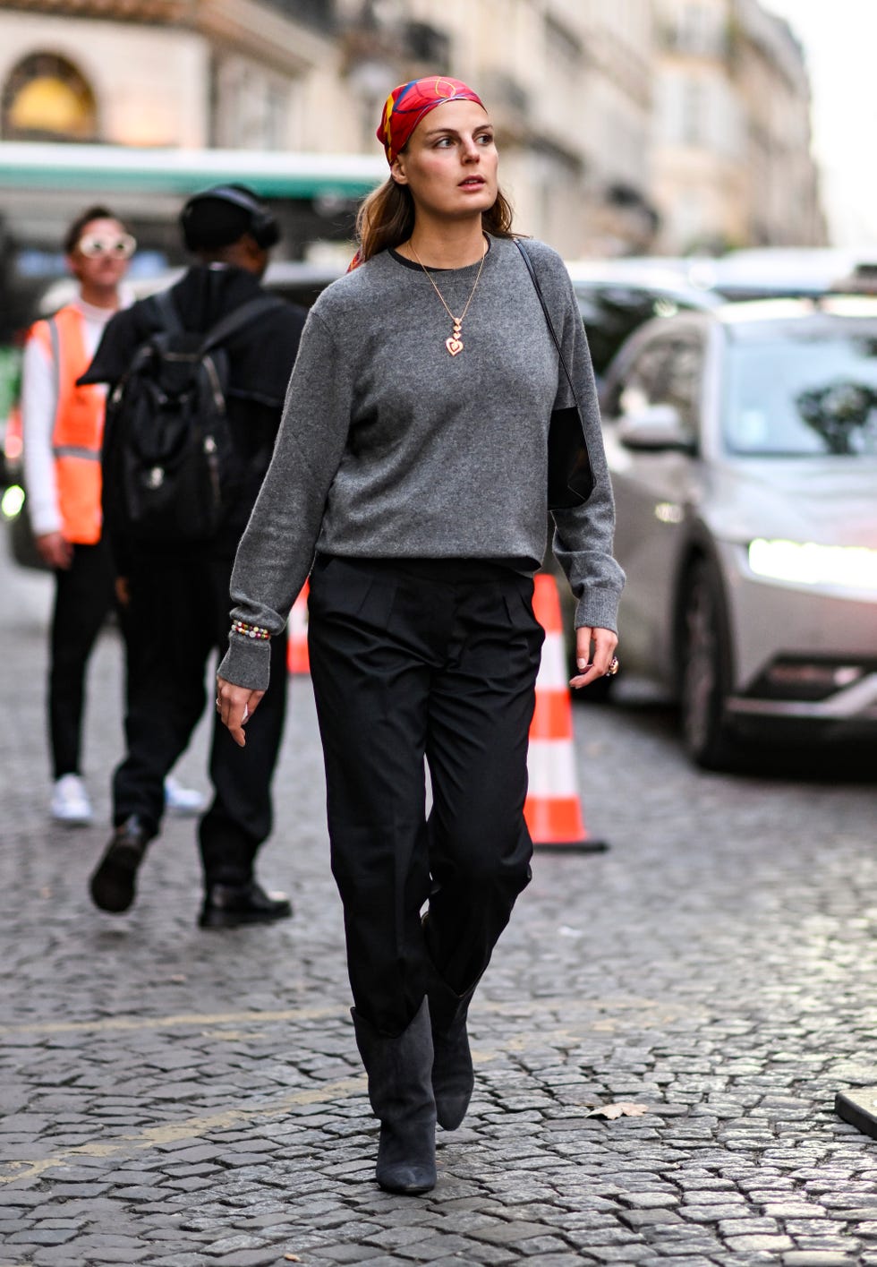 paris, france september 29 a guest is seen wearing a gray sweater, black pants and red headscarf outside the isabel marant show during womenswear springsummer2025 as part of paris fashion week on september 29, 2024 in paris, france photo by daniel zuchnikgetty images