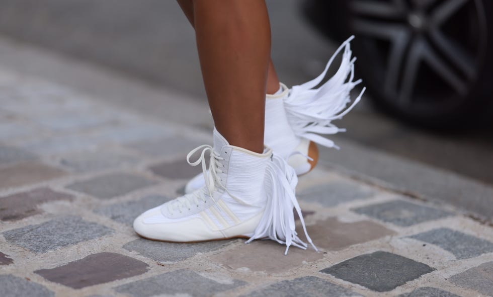 Xochitl Gomez wears Adidas x Stella McCartney shoelace fringe before the Stella McCartney Womenswear Spring/Summer 2025 Collection show as part of Paris Fashion Week on September 30, 2024 in Paris, France She is seen wearing white and cream white high-top sneakers with a Photo credit: Jeremy Moraghetti Images