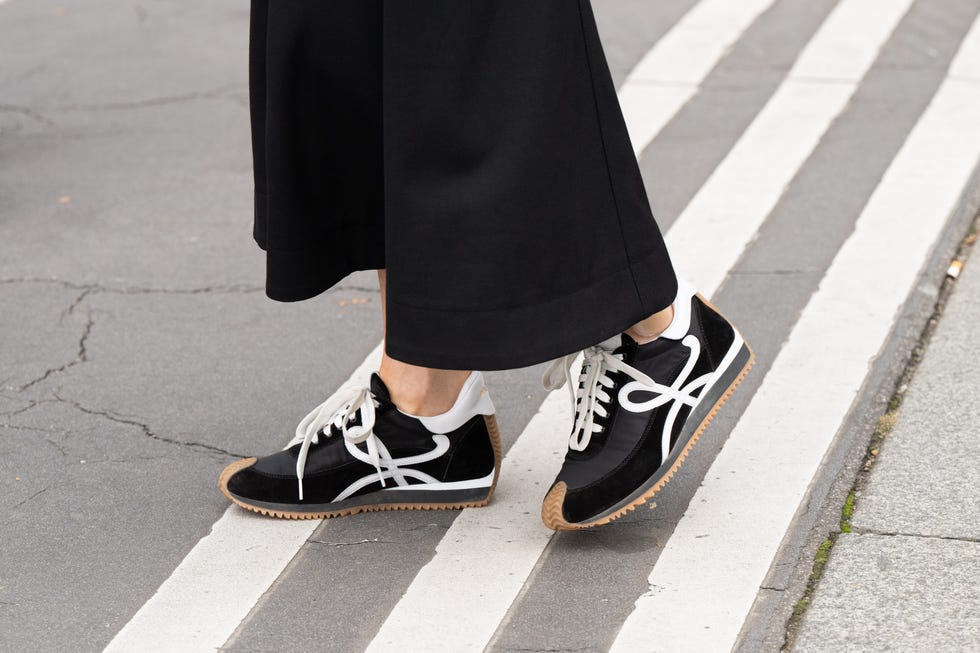 paris, france september 28 a guest wears loewe trainers and wide leg black trousers outside the hermes show during womenswear springsummer 2025 as part of paris fashion week on september 28, 2024 in paris, france photo by kirstin sinclairgetty images