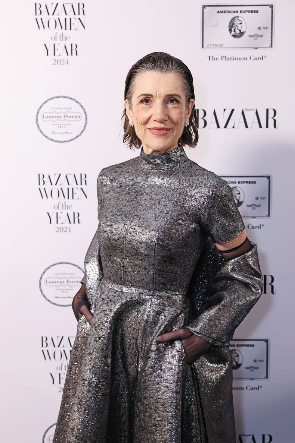 a woman in a metallic silver dress at a fashion event