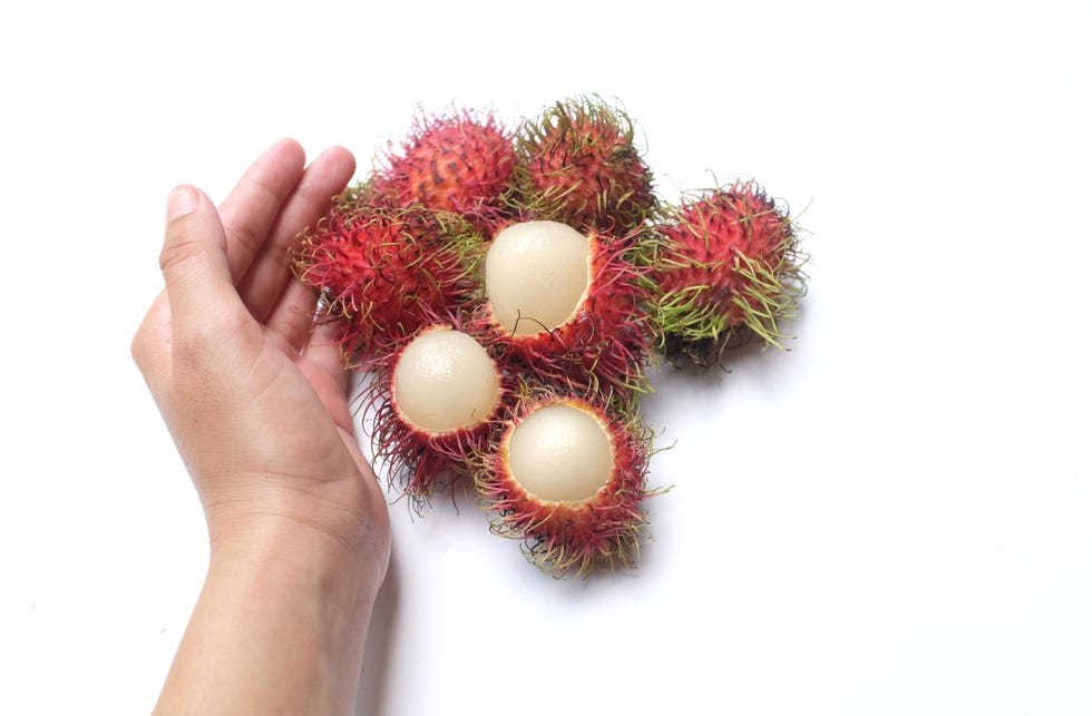 partly peeled mangosteen and rambutans, closeup