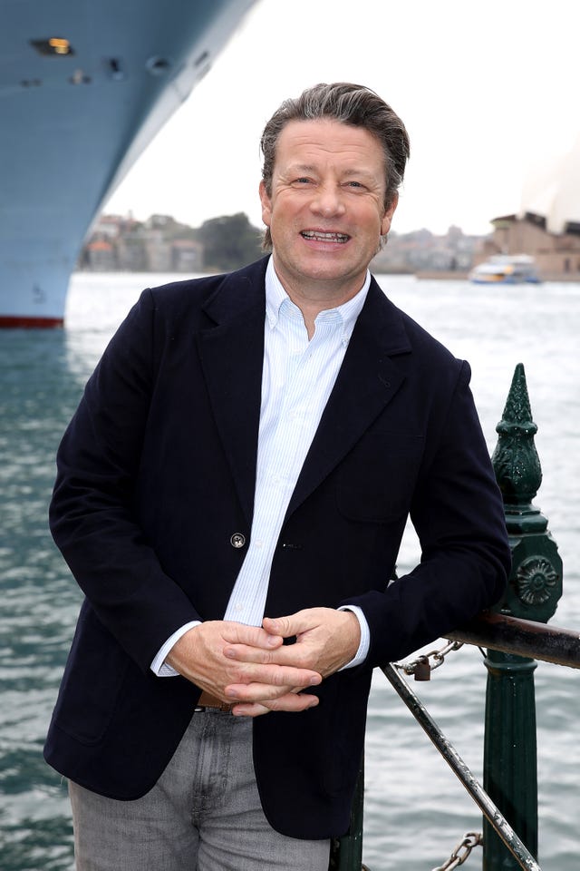 sydney, australia november 13: jamie oliver poses for a photo in front of royal caribbeans ovation of the seas berthed at circular quay, ahead of the inaugural jamie oliver food hero awards 2024, in partnership with royal caribbean international and wonde on november 13, 2024 in sydney, australia. (photo by rocket weijers/getty images for jamie oliver ltd)