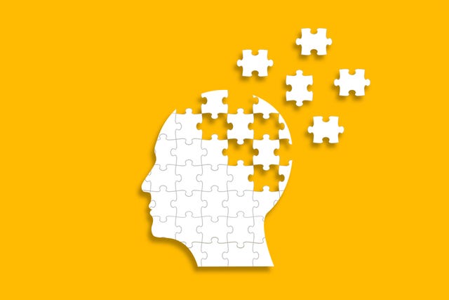 dementia and parkinsons disease head and brain diseases concept human head shaped puzzle on yellow background