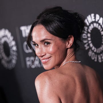 a woman with her back to the viewer showcasing a formal event setting a woman with her back to the viewer showcasing a formal event setting