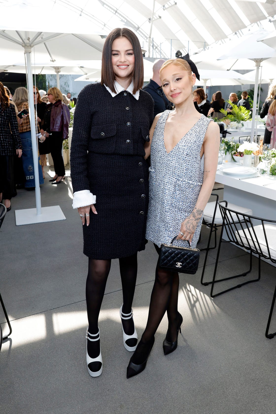 los angeles, california december 10 l r selena gomez, wearing chanel, and ariana grande, wearing chanel, attend the academy womens luncheon presented by chanel at the academy museum of motion pictures on december 10, 2024 in los angeles, california photo by stefanie keenanwireimage