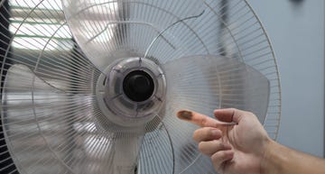 close up finger hand dirty and dust on floor fan. unhealthy air flow for respiratory system, wipe, rub and wash at least 1 time per month, big cleaning day in home concept. selective focus image.