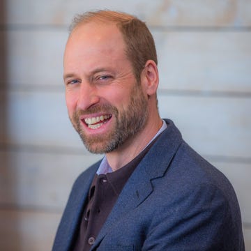 man engaged in a discussion wearing a suit in a casual setting man engaged in a discussion wearing a suit in a casual setting