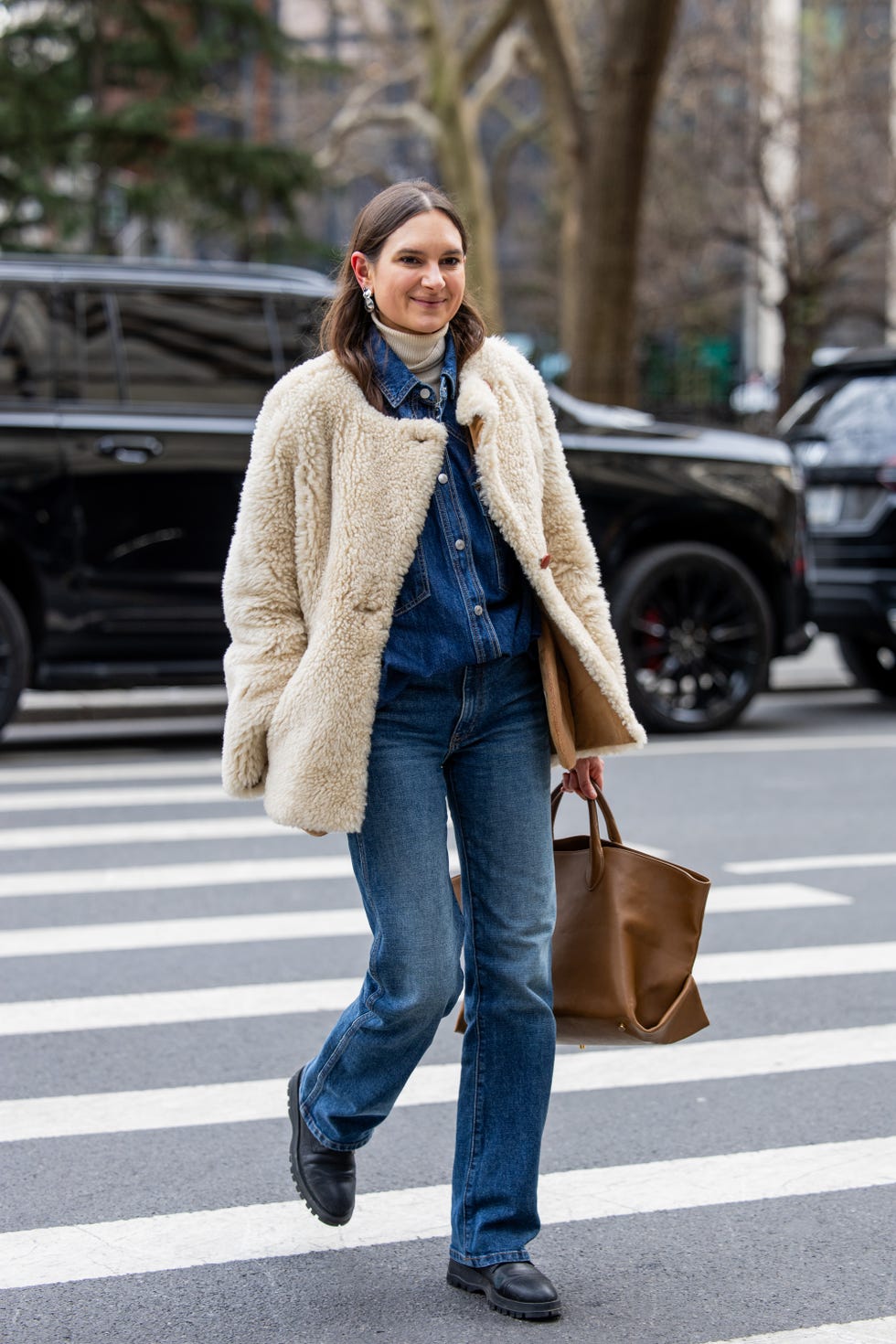 new york, new york february 08 a guest wears beige teddy jacket, jeans, shirt, brown bag outside altuzarra during new york fashion week on february 08, 2025 in new york city photo by christian vieriggetty images