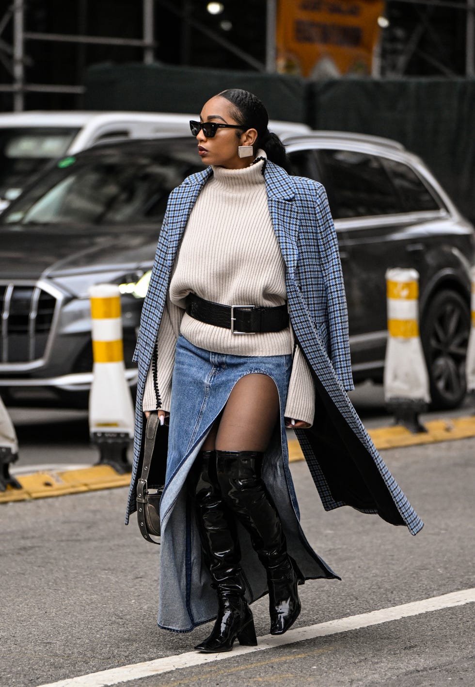 new york, new york february 08 a guest is seen wearing a blue plaid coat, cream sweater, jean skirt, black boots and black belt with black sunglasses outside the altuzarra show during nyfw fw 2025 on february 08, 2025 in new york city photo by daniel zuchnikgetty images