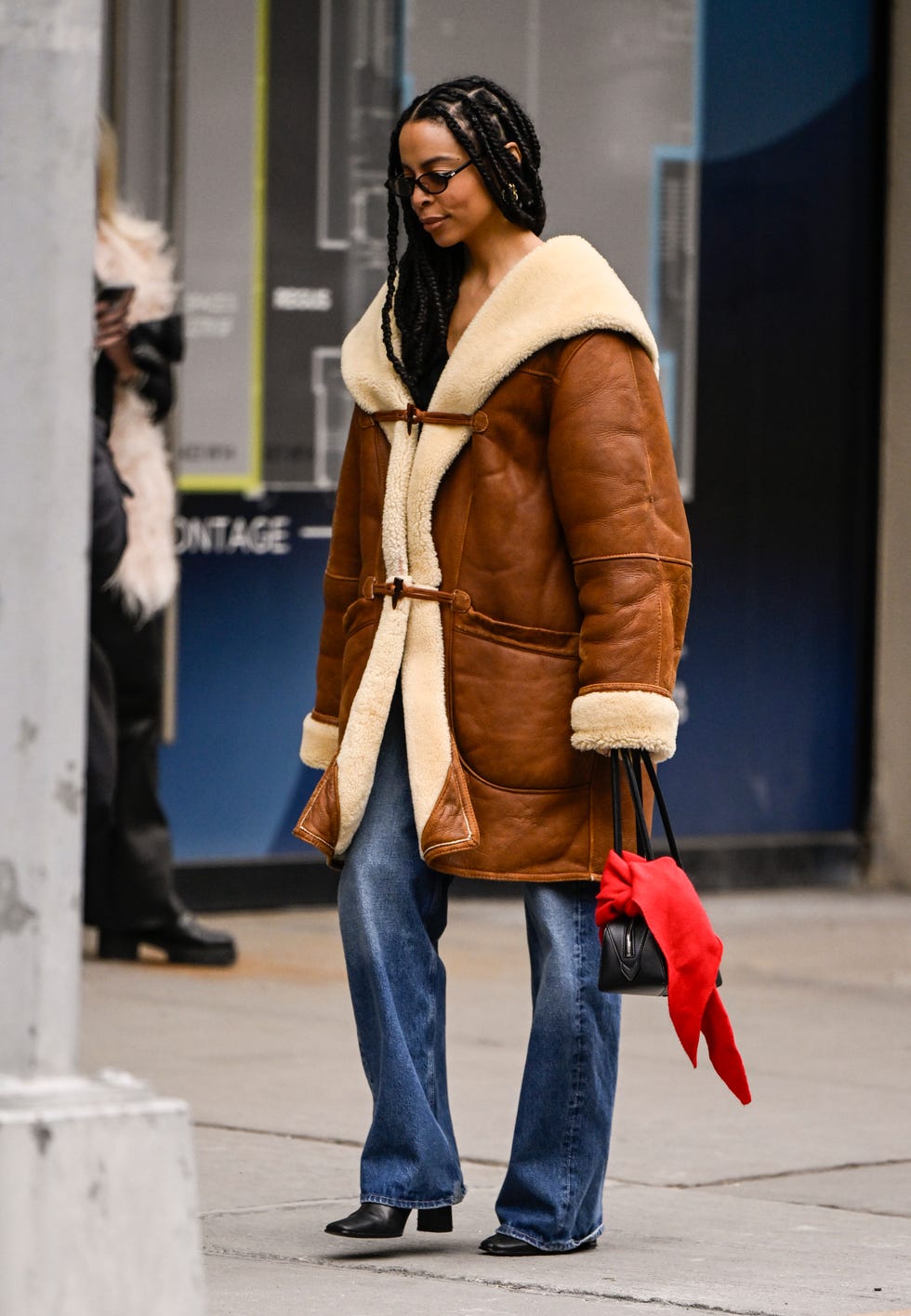 new york, new york february 08 a guest is seen wearing a tan faux fur trim coat, blue jeans, black bag with red scarf and black shoes outside the alice and olivia presentation during nyfw fw 2025 on february 08, 2025 in new york city photo by daniel zuchnikgetty images