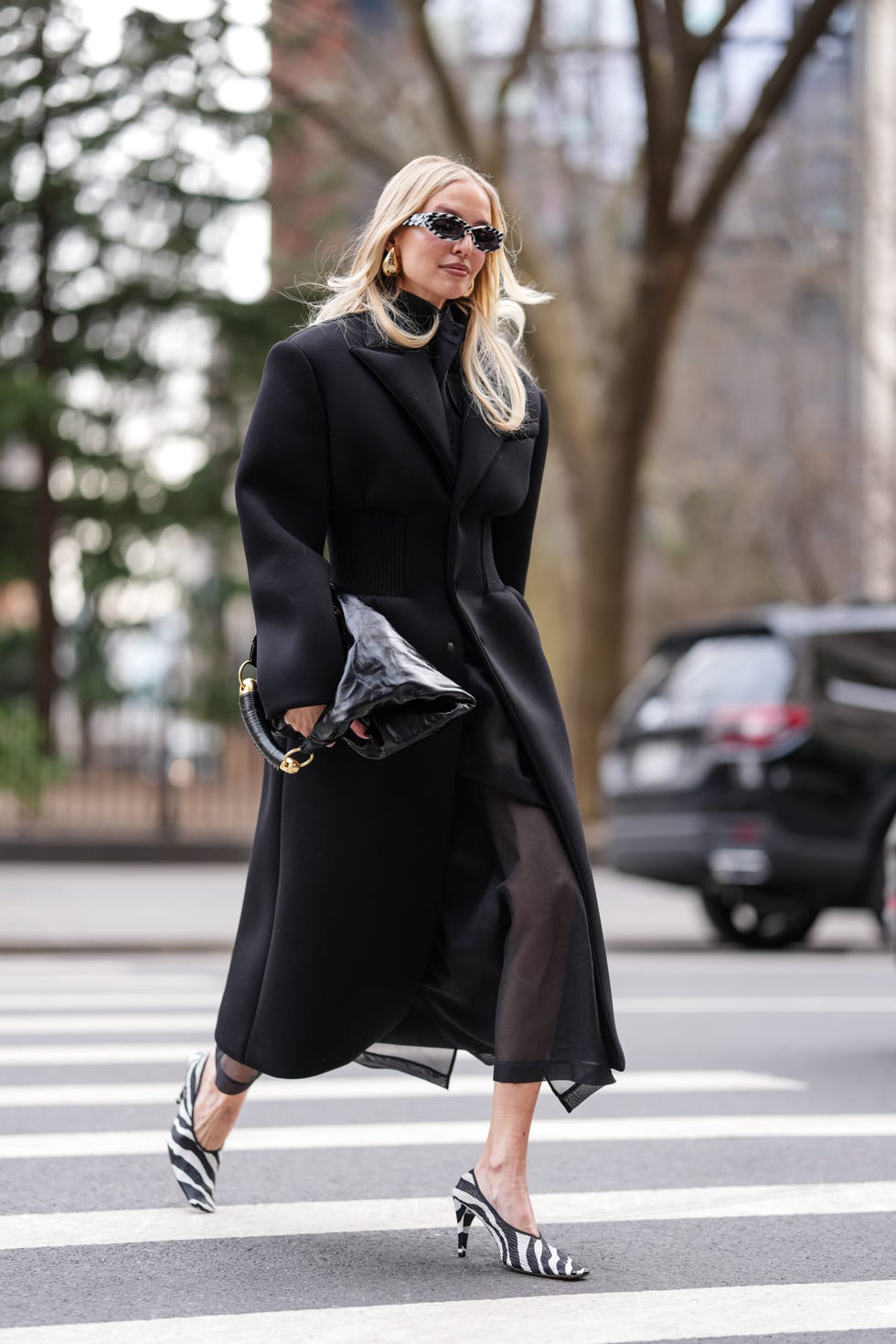 new york, new york february 08 leonie hanne wears black white zebra patternprint cat eye celine sunglasses, gold earrings, black sheer mesh midi dress, black tailored blazer wardrobe nyc coat, black white zebra patternprint magda butrym heels leather shoes, shiny black leather altuzarra athena leather hobo bag, outside altuzarra, during the new york fashion week fallwinter 2025 on february 8, 2025 in new york, new york photo by edward berthelotgetty images