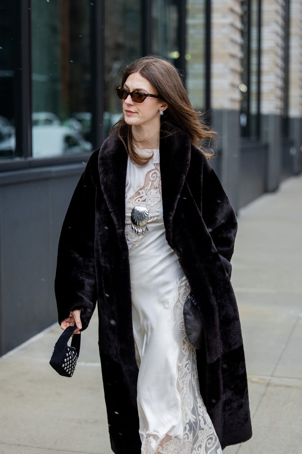 new york, new york february 09 a guest wears white dress, black fur coat outside ulla johnson during new york fashion week on february 09, 2025 in new york city photo by christian vieriggetty images