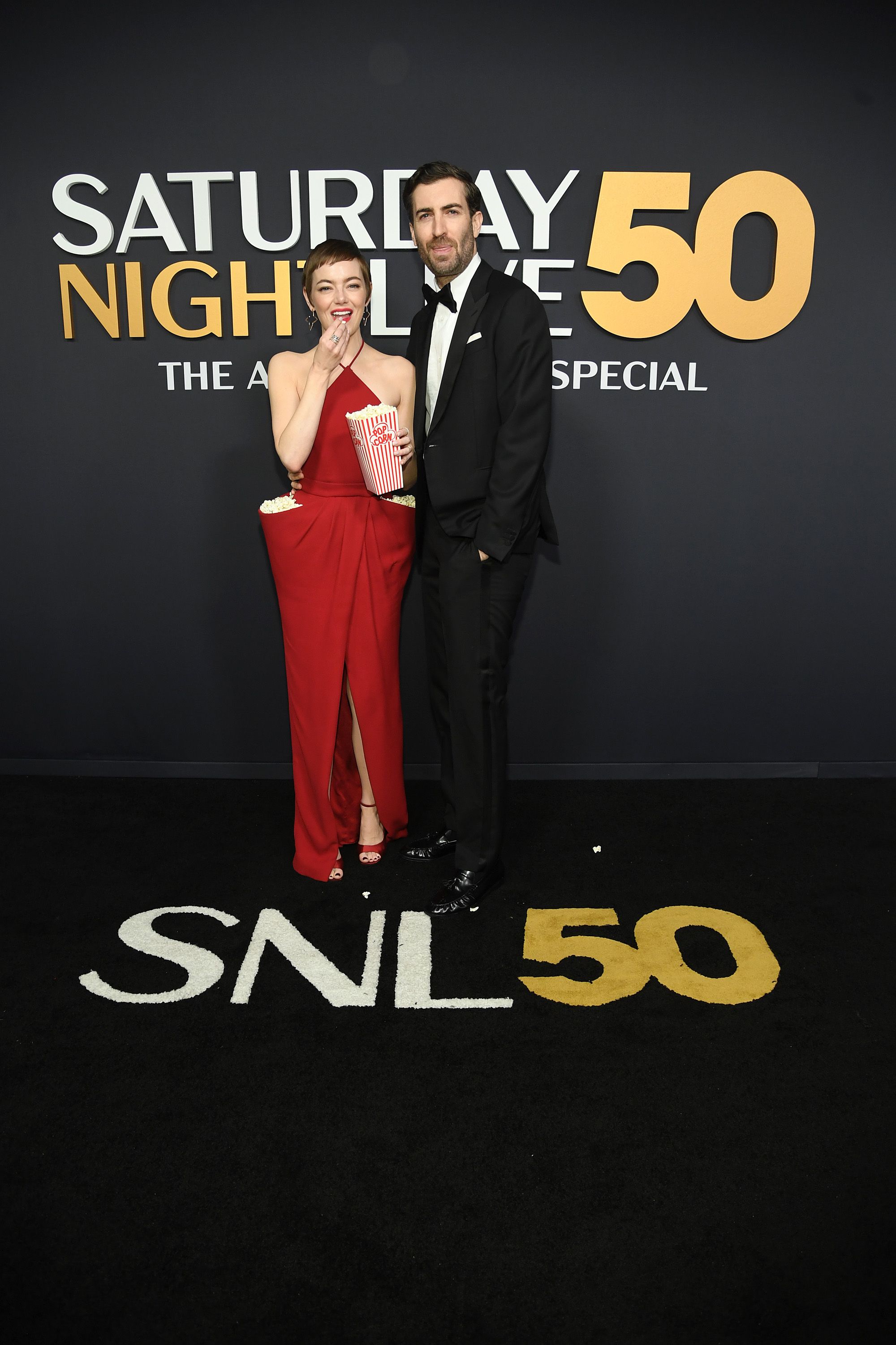 Emma Stone Stuffs Her Dress Pockets With Popcorn for <i>SNL50</i>