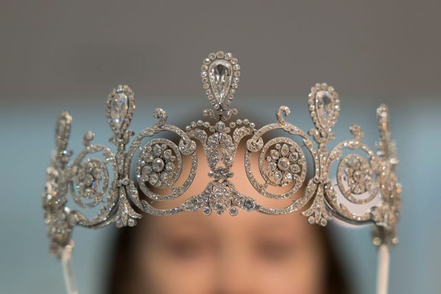 london, england april 9: staff pose for photos behind a tiara inside the cartier exhibition at the va on april 9, 2025 in london, england. (photo by belinda jiao/getty images)