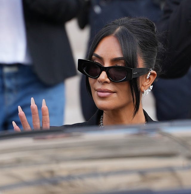 paris, france may 13: kim kardashian exits the trial at the palais de justice, and wears sunglasses by alaia, repossi diamond earcuffs, brioni raymond earrings, at the palais de justice, on may 13, 2025 in paris, france. (photo by edward berthelot/gc images)