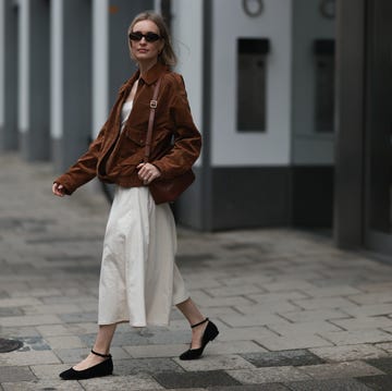 Street Style - Hamburg - May, 2025 hamburg, germany may 28: marlies pia pfeifhofer is seen wearing oval tortoiseshell framed sunglasses from corlin, gold hoop earrings from ole lynggaard, an oversized brown suede jacket from zara, an off white denim a line dress from zara, a rectangular brown leather puzzle bag from loewe, a silver diamond studded ring, and black suede mary jane ballerina flats from chatelles on may 28, 2025 in hamburg, germany. (photo by jeremy moeller/getty images)