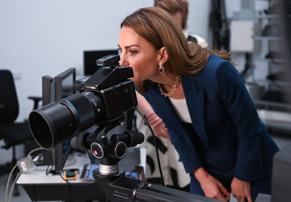 britain's catherine, princess of wales looks through the viewfinder of a camera in the photographic studio during a visit to the va east storehouse, a brand new cultural destination in east london, on june 10, 2025. (photo by eddie mulholland / pool / afp)