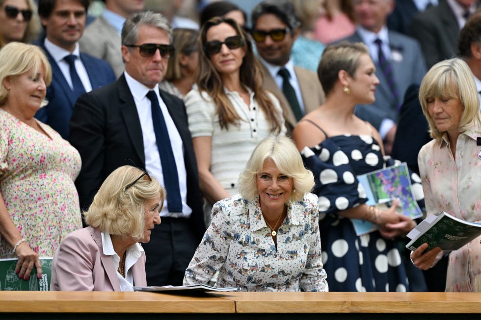 britain's queen camilla (c) arrives next to chair of the all england lawn tennis and croquet club board deborah jevans (r), british actor hugh grant and his wife swedish producer anna elisabet eberstein in the royal box of centre court for the women's singles quarter final tennis match between russia's mirra andreeva and switzerland's belinda bencic on the tenth day of the 2025 wimbledon championships at the all england lawn tennis and croquet club in wimbledon, southwest london, on july 9, 2025. (photo by glyn kirk / afp) / restricted to editorial use