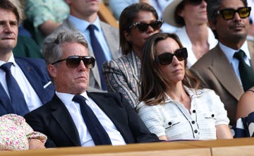 london, england july 09: actor, hugh grant and anna elisabet eberstein watch in the royal box during the gentlemens singles quarter final match between flavio cobolli of italy and novak djokovic of serbia on day ten of the championships wimbledon 2025 at all england lawn tennis and croquet club on july 09, 2025 in london, england. (photo by clive brunskill/getty images)