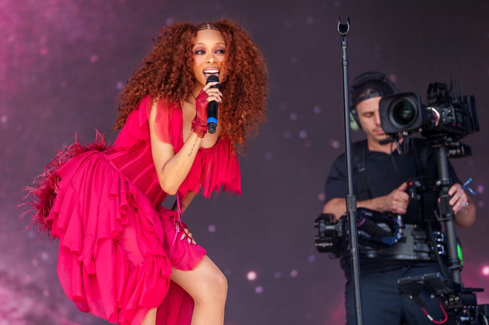 singer performing on stage with a microphone