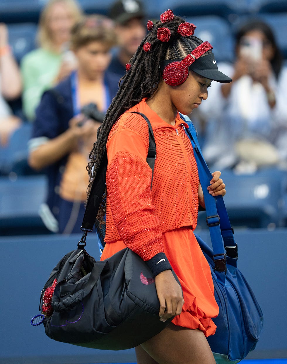 new york, new york august 25: naomi osaka of japan enters the court for her women's singles first round match on day three against greet minnen of belgium at the 2025 us open at usta billie jean king national tennis center on august 24, 2025 in new york city. (photo by susan mullane/isi photos/isi photos via getty images)