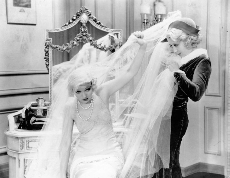 american comic actress joan blondell 1909   1979 struggles with the cumbersome veil of a wedding dress in a scene from an unknown film   photo by hulton archivegetty images