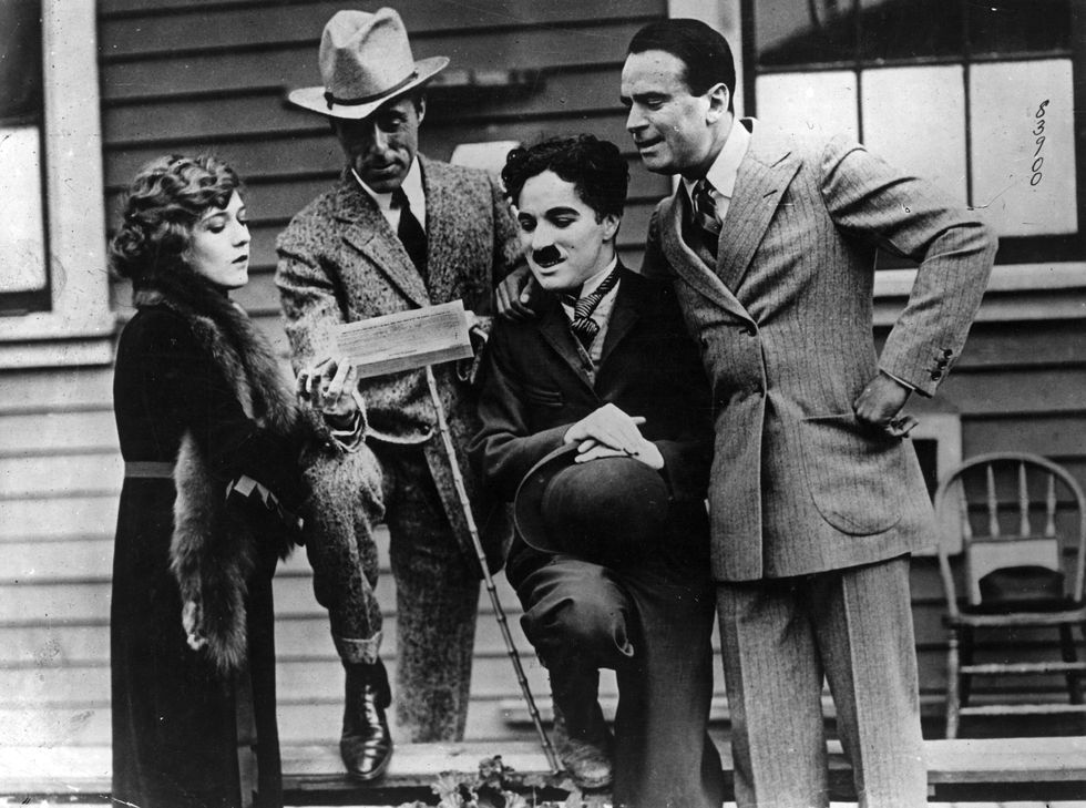 english film actor and director charles spencer chaplin 1889   1977 with american actress mary pickford 1893   1979, american actor douglas fairbanks 1883   1939 and american film director david wark griffith 1875   1948 on the day they formed the united artists corporation   photo by topical press agencygetty images
