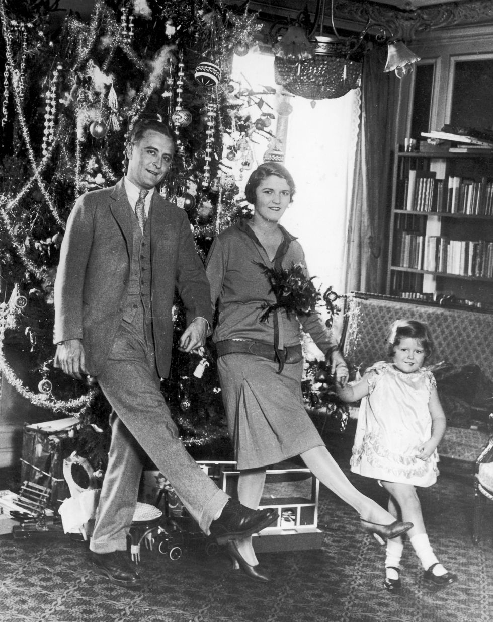 american author f scott fitzgerald 1896   1940 dances with his wife zelda fitzgerald nee sayre 1900   1948 and daughter frances aka scottie in front of the christmas tree in paris   photo by hulton archivegetty images