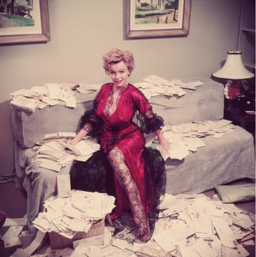 premium rates apply marilyn monroe 1926 1962, wearing a red negligee trimmed with black lace, sorts out her fan mail shortly after her film the asphalt jungle had been released original publication a wonderful time slim aarons photo by slim aaronsgetty images