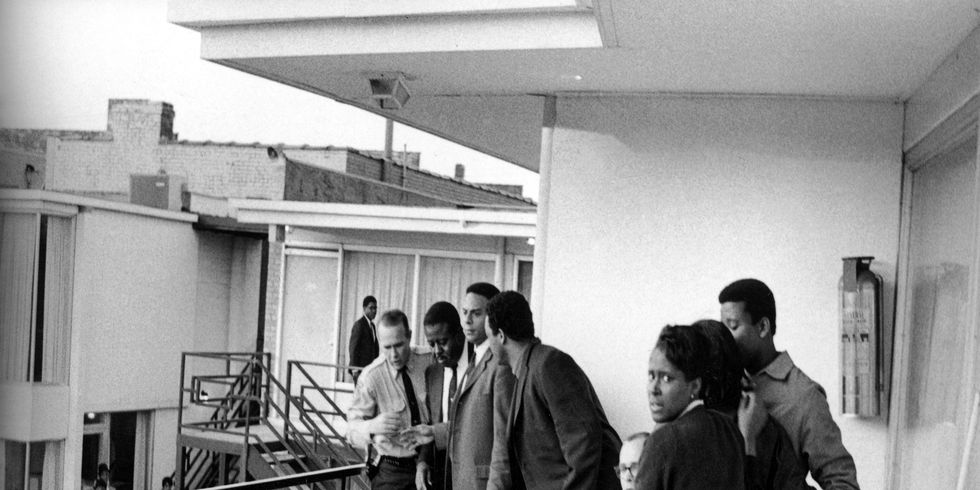 Police stand with civil rights leaders (L-R) Ralph Abernathy, Andrew Young, Jesse Jackson and others on the balcony of the Lorraine Motel over the body of Martin Luther King Jr.