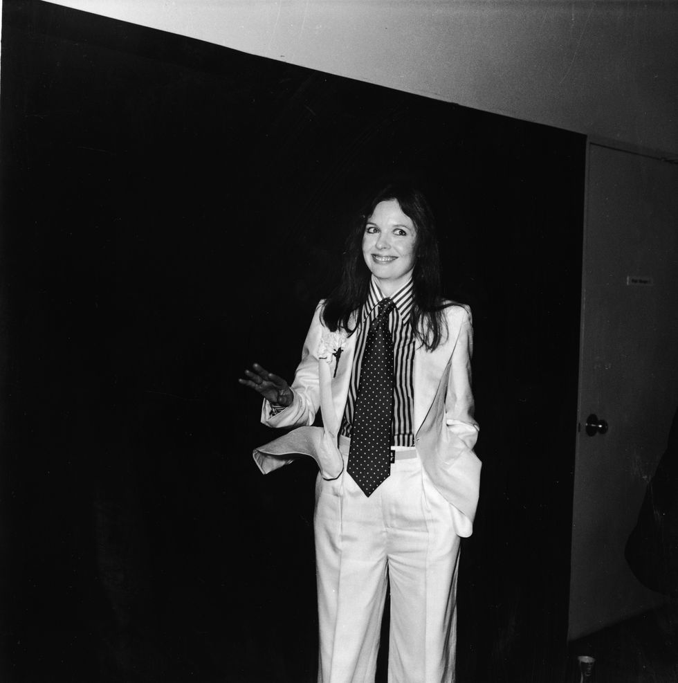 american actor and director diane keaton poses with a big smile and tilted head at the 48th academy awards and wears a white suit with a carnation in the lapel, striped shirt, and polka dot tie, los angeles, california, march 29, 1976 photo by frank edwardsfotos internationalgetty images